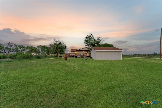 1236 County Road 7611, Devine, TX 78016 - view of grassy yard featuring a deck, an outdoor structure, and a pole building