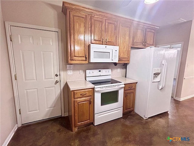 kitchen with brown cabinets, white appliances, light countertops, and concrete flooring