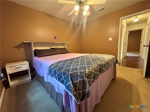 carpeted bedroom with visible vents and ceiling fan