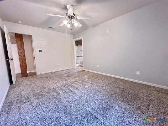 carpeted empty room featuring a ceiling fan, visible vents, and baseboards