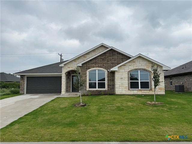 141 Atlas Ave, Killeen, TX 76542 - french country inspired facade featuring an attached garage, concrete driveway, a front yard, central AC, and brick siding