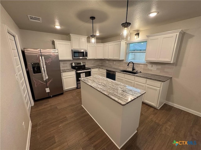 141 Atlas Ave, Killeen, TX 76542 - kitchen with stainless steel appliances, a sink, decorative backsplash, and white cabinets
