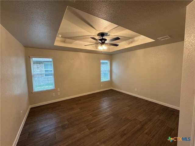 141 Atlas Ave, Killeen, TX 76542 - unfurnished room with a tray ceiling, a textured ceiling, dark wood-type flooring, crown molding, and ceiling fan