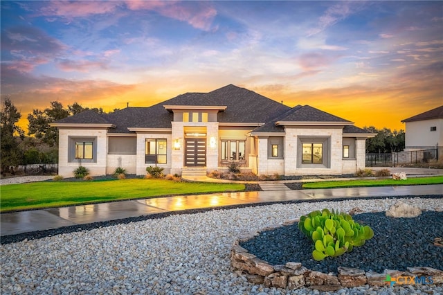 prairie-style home featuring a lawn