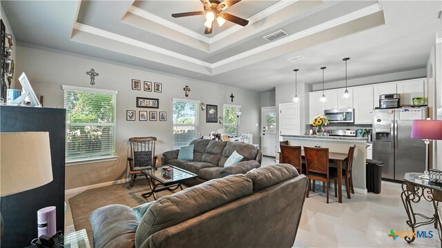 911-913 E Seideman St, Seguin, TX 78155 - living area featuring a raised ceiling, ceiling fan, and ornamental molding