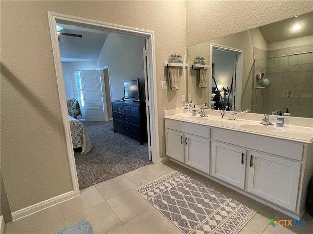 bathroom with tile patterned floors, an enclosed shower, vanity, vaulted ceiling, and ceiling fan