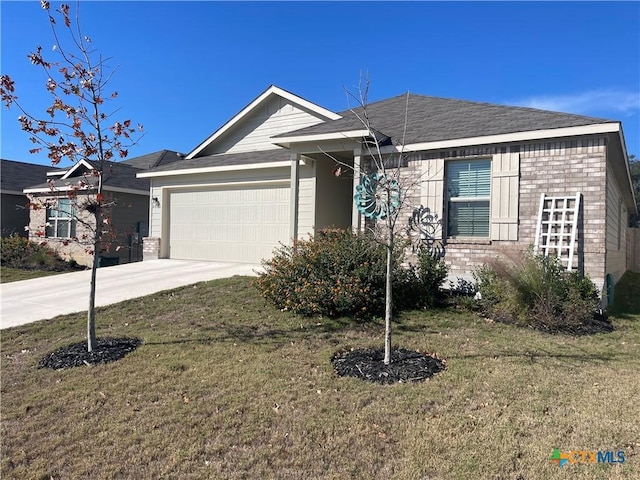 view of front of property featuring a garage and a front lawn