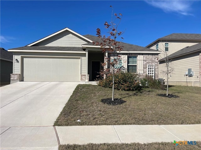 view of front of home with a front yard and a garage