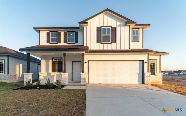 view of front of house featuring board and batten siding, concrete driveway, covered porch, and an attached garage