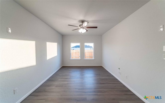 unfurnished room with a ceiling fan, baseboards, and wood finished floors