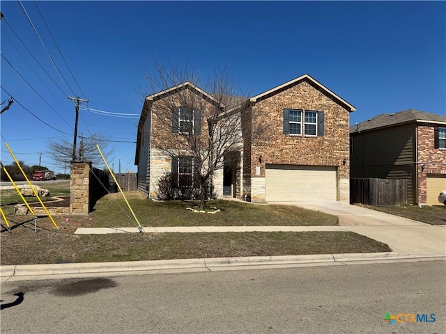 traditional-style house featuring a garage, fence, concrete driveway, and brick siding