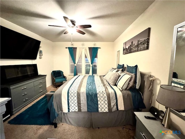 bedroom featuring a ceiling fan and dark colored carpet