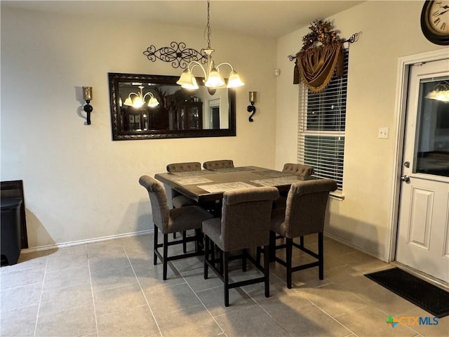 dining area featuring baseboards, a chandelier, and tile patterned floors