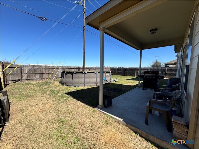 view of yard with a fenced backyard, a fenced in pool, and a patio