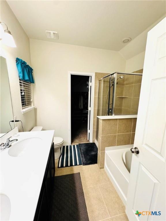 full bath with toilet, a tub, tile patterned floors, a tile shower, and vanity