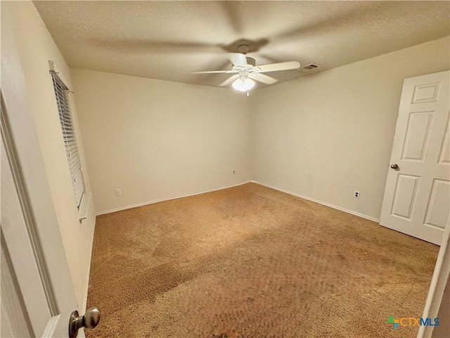 unfurnished bedroom with carpet floors, visible vents, ceiling fan, a textured ceiling, and baseboards