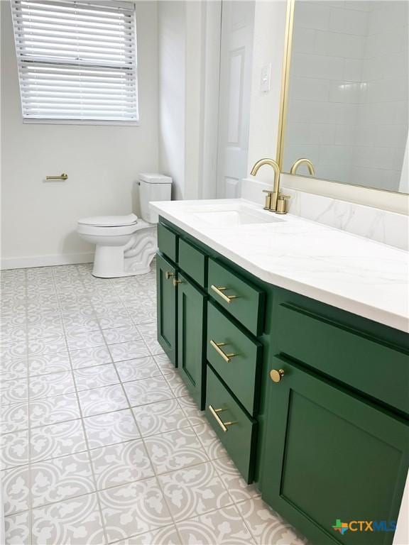 bathroom featuring tile patterned floors, vanity, and toilet