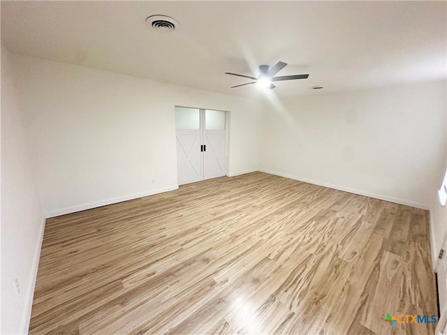 unfurnished room featuring ceiling fan and light hardwood / wood-style flooring