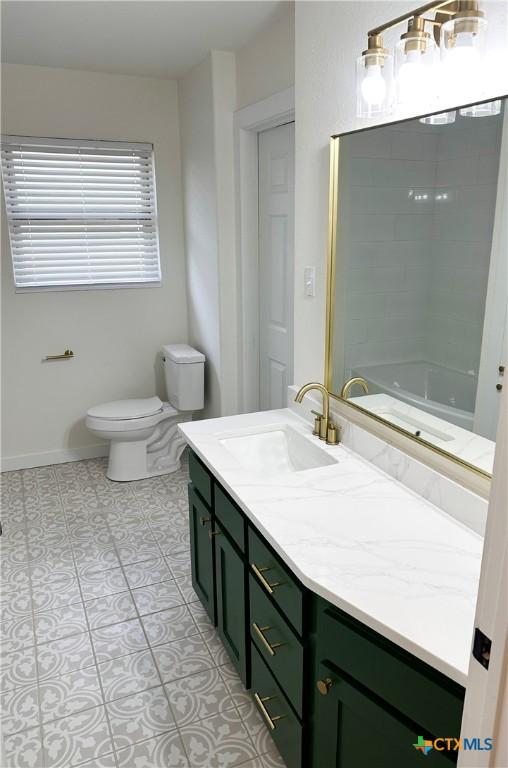 bathroom with tile patterned floors, vanity, and toilet