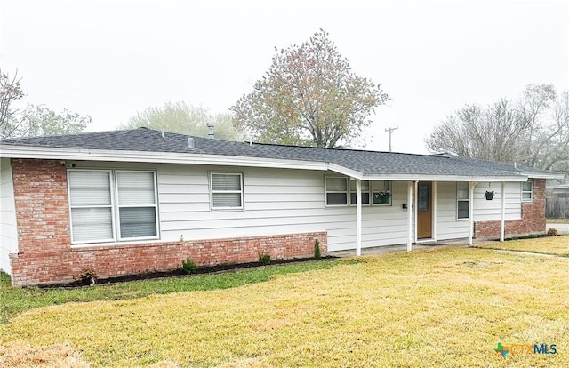 back of property featuring a lawn