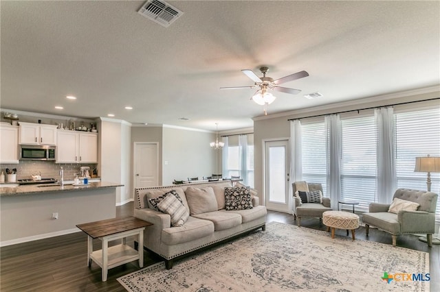 611 Hawks Shadow Dr, Temple, TX 76502 - living area with crown molding, ceiling fan, dark wood-style floors, recessed lighting, and baseboards