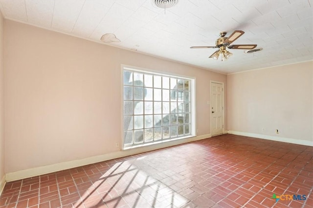 unfurnished room featuring brick floor, visible vents, ceiling fan, and baseboards