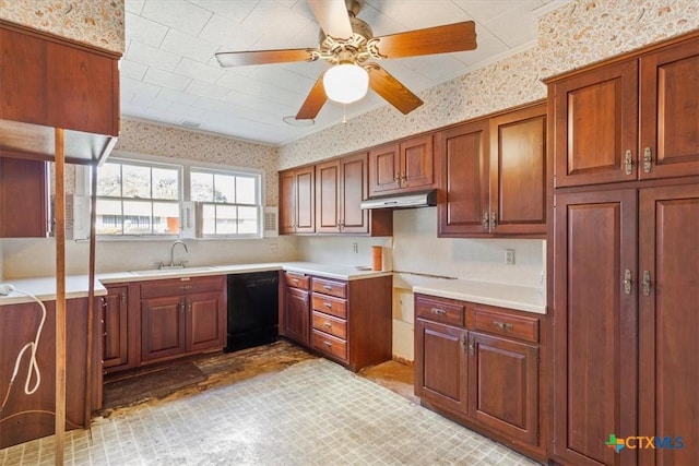 kitchen featuring under cabinet range hood, a sink, light countertops, dishwasher, and wallpapered walls