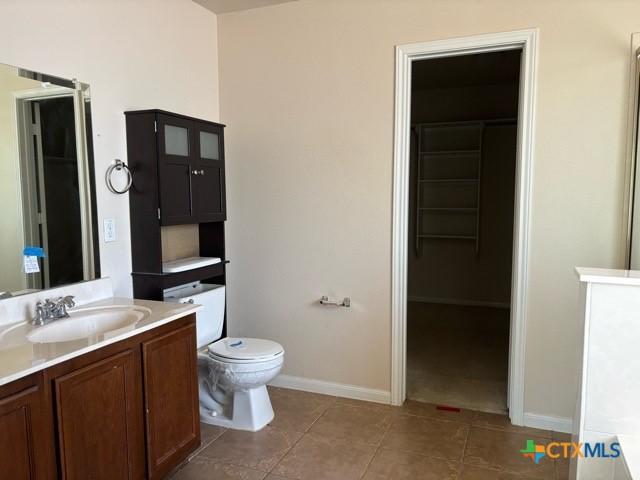 224 Starlight Dr, Temple, TX 76502 - full bath featuring baseboards, vanity, tile patterned flooring, and toilet