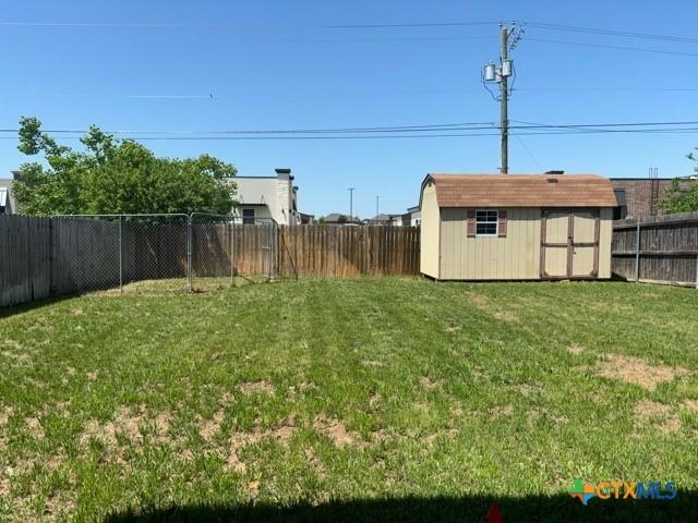 224 Starlight Dr, Temple, TX 76502 - view of yard featuring a fenced backyard, an outbuilding, and a storage shed