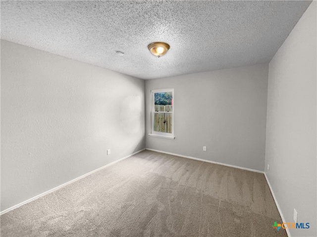 carpeted spare room with a textured ceiling