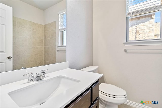 bathroom featuring vanity and toilet