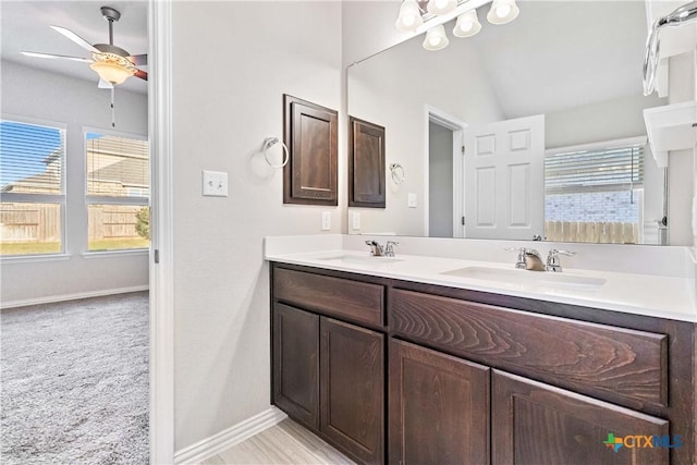 bathroom featuring vanity, vaulted ceiling, and ceiling fan