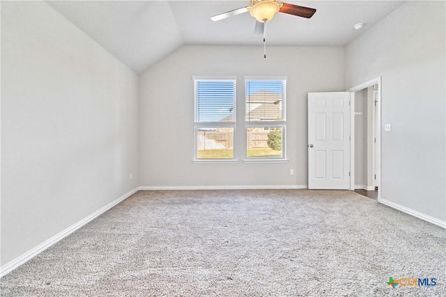 carpeted spare room with lofted ceiling and ceiling fan