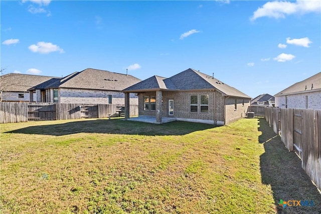 back of house with a patio and a yard