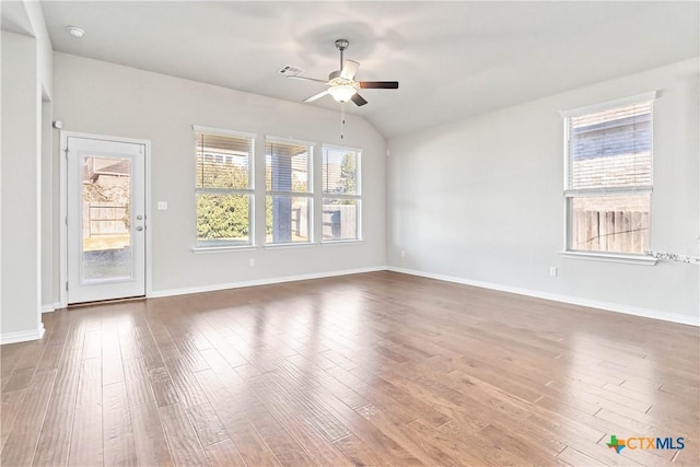 unfurnished room featuring hardwood / wood-style flooring, lofted ceiling, and ceiling fan