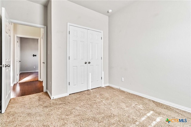 unfurnished bedroom featuring carpet floors and a closet