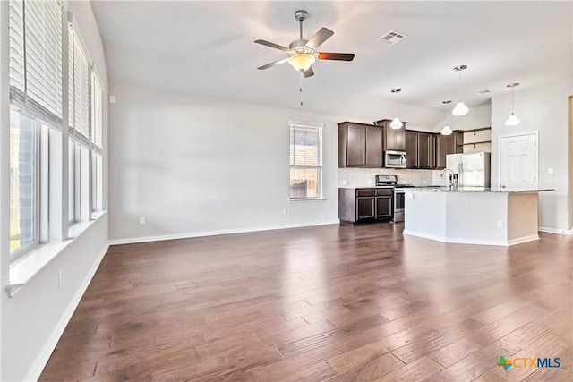 unfurnished living room with lofted ceiling, dark hardwood / wood-style floors, and ceiling fan