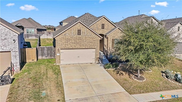 view of front of home with a garage and a front lawn