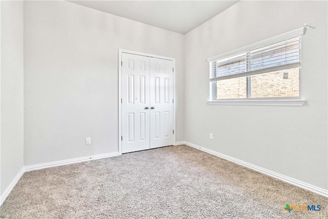 unfurnished bedroom with carpet floors and a closet