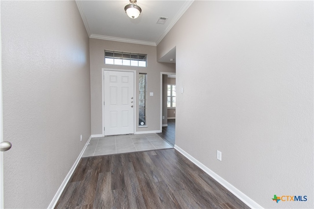 entryway with dark hardwood / wood-style flooring and crown molding