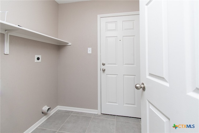 washroom featuring electric dryer hookup and light tile patterned floors