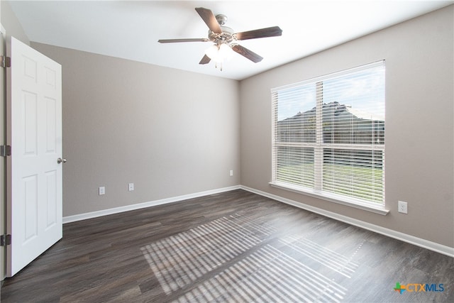 spare room with ceiling fan and dark hardwood / wood-style flooring