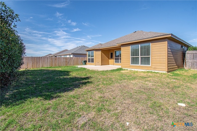 back of property featuring a patio and a lawn