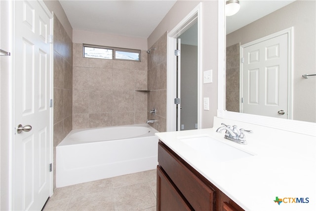 bathroom with tile patterned flooring, vanity, and tiled shower / bath