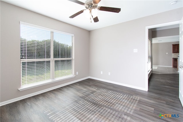 unfurnished room with ceiling fan and dark hardwood / wood-style flooring