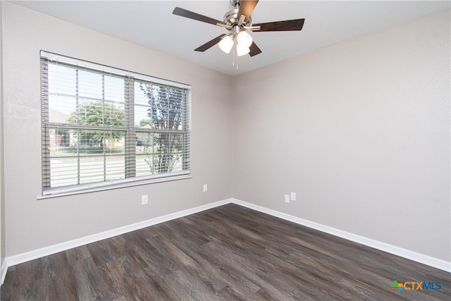 spare room with dark hardwood / wood-style flooring and ceiling fan