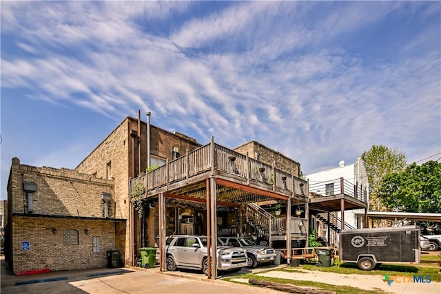 122 E Main St, Cuero, TX 77954 - view of building exterior with stairway and uncovered parking
