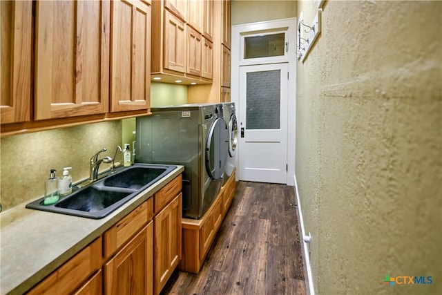 122 E Main St, Cuero, TX 77954 - laundry area with washer and clothes dryer, cabinet space, and dark wood finished floors