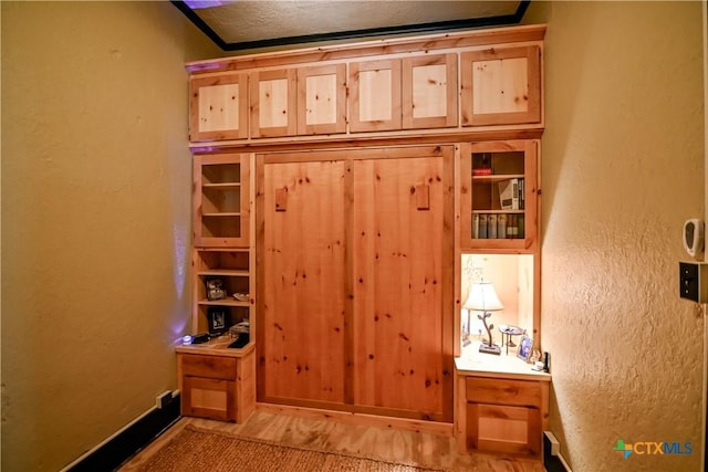122 E Main St, Cuero, TX 77954 - detailed view of wood finished floors, baseboards, and a textured wall
