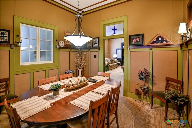 122 E Main St, Cuero, TX 77954 - dining area featuring a decorative wall, ornamental molding, and wood finished floors